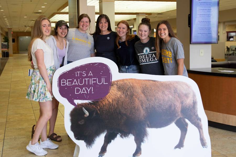 Dr. McQueen with students and bison