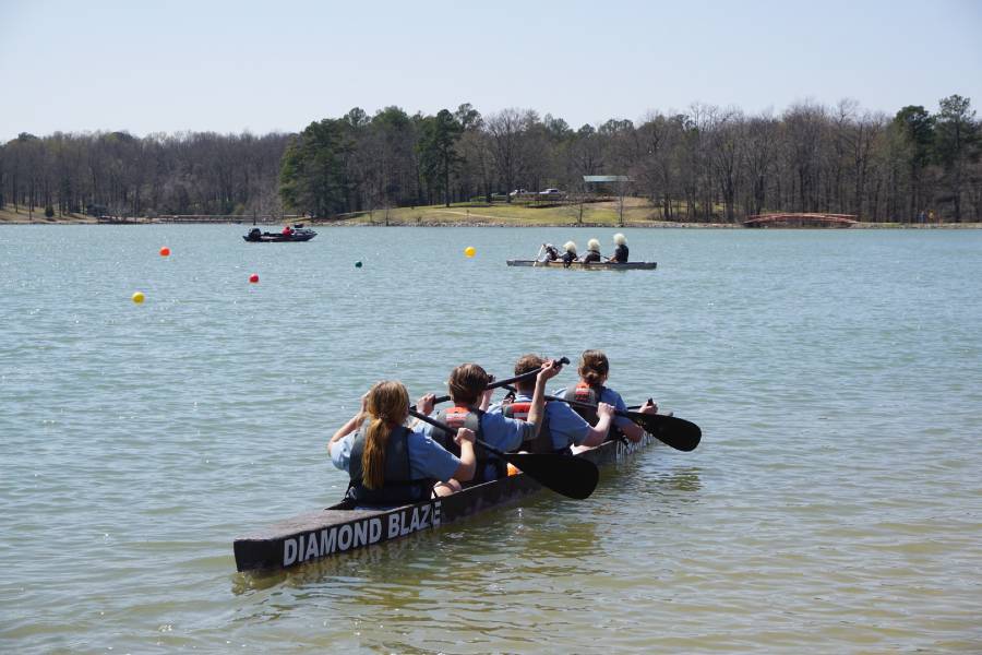 Engineering students floating in the concrete canoe. 