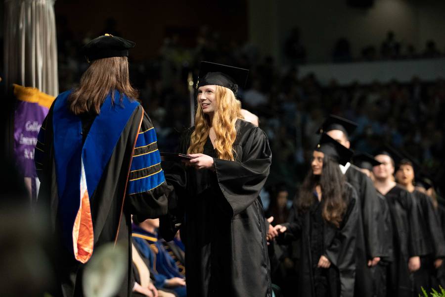 Female graduation receives diploma