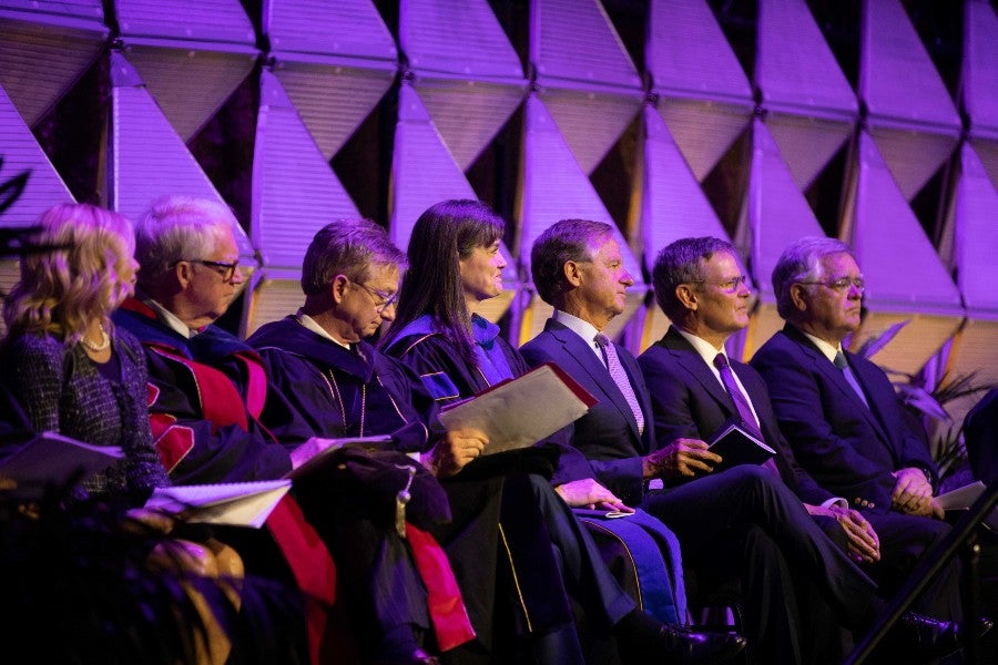 Dignitaries on stage with President McQueen at the March inauguration ceremony