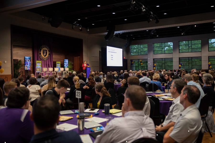 Faculty and staff gathered in the George Shinn Center. 