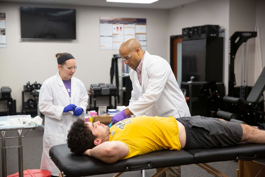 Dr. Jeremey Townsend (right) has authored, co-authored with his exercise science and nutrition students or contributed to 40 articles published in peer-reviewed journals since 2016. Here student Megan Jones assists him with taking tissue samples. 