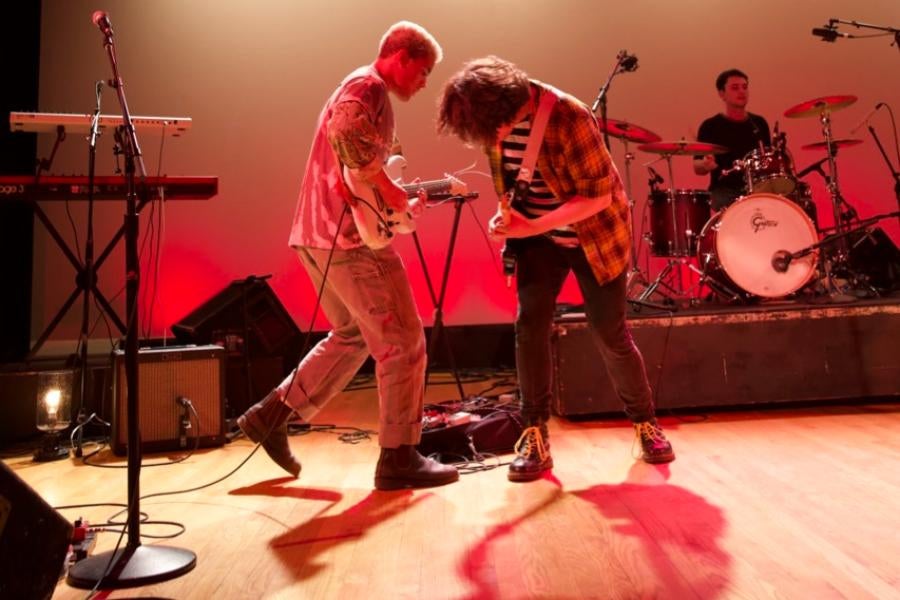 A rock band playing at a concert 