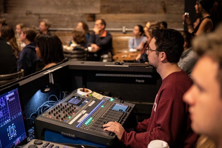 A boy using a sound board for a performance 