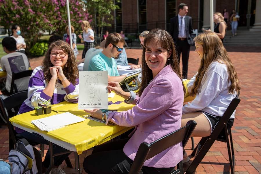 Dr. McQueen in Bison Square with students.