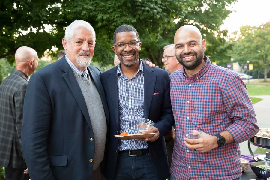 Three faculty at reception