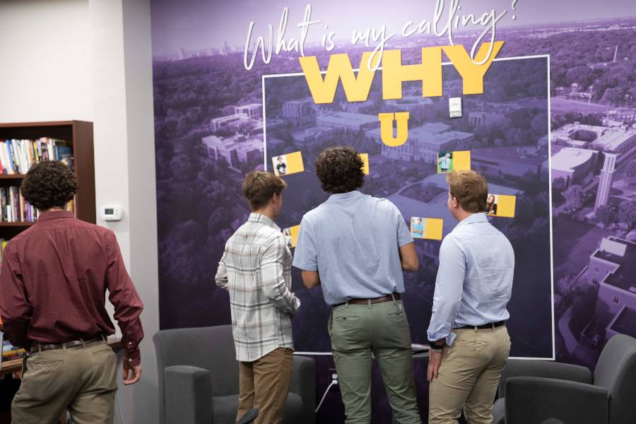 Students looking at the WHY wall.