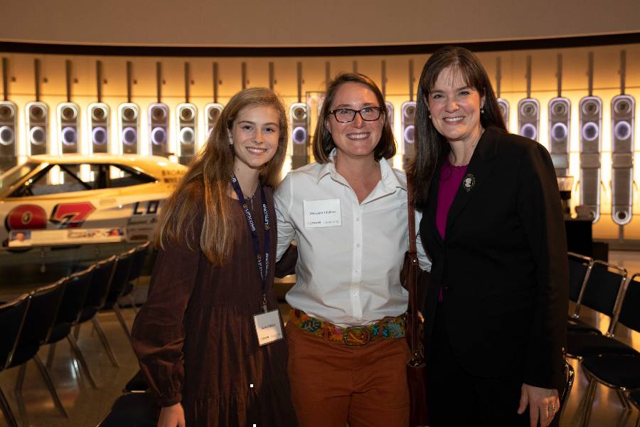 Two alumni with President McQueen