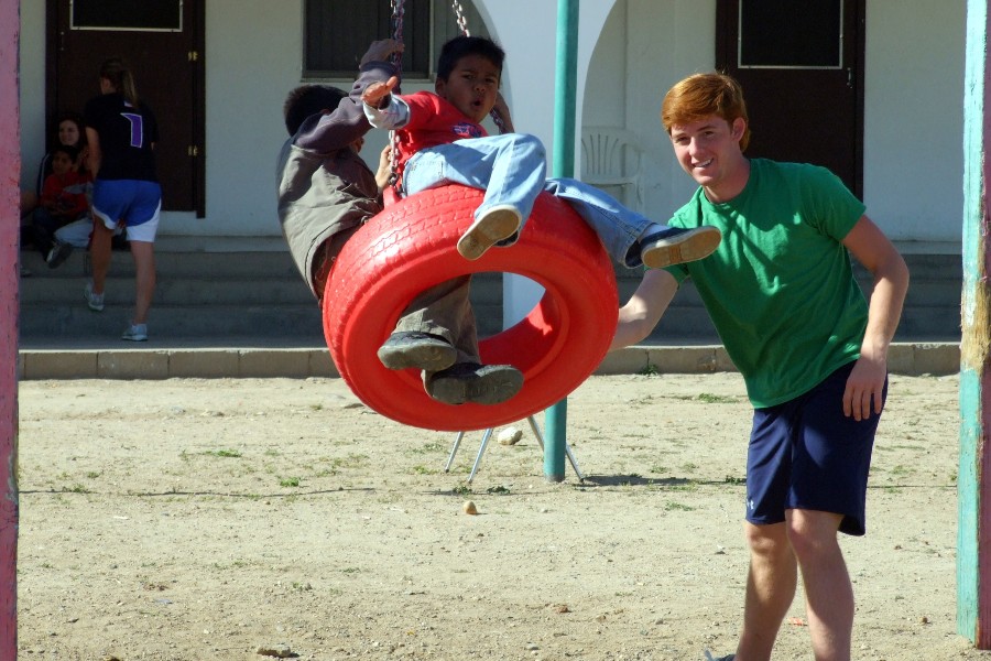 Lipscomb student with child on a playground