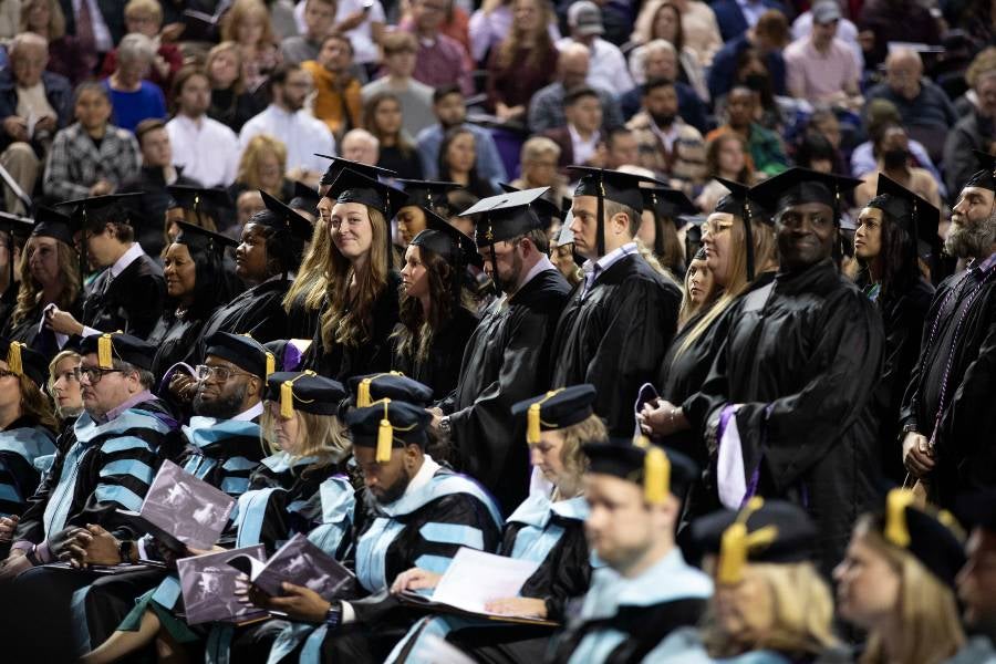 Students waiting to receive their master's degrees. 