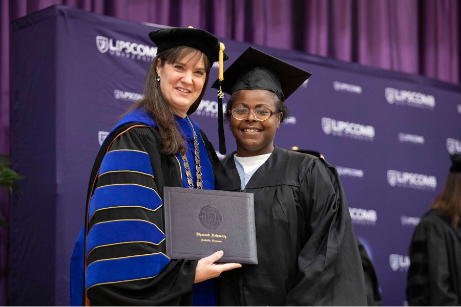 Graduate Evetta with Lipscomb President receiving degree