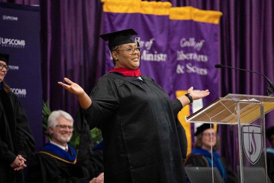 Graduate ReAsha speaks to the crowd during the ceremony