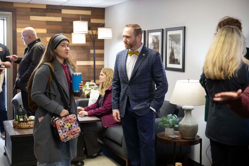 Faculty socializing during the grand opening of the student veteran resource lounge