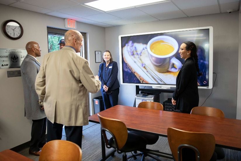 Inside desk and TV area of the student veteran resource lounge during the grand opening