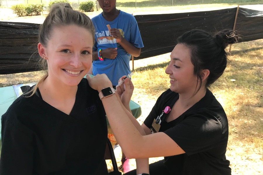 Hannah Peterson giving a vaccine