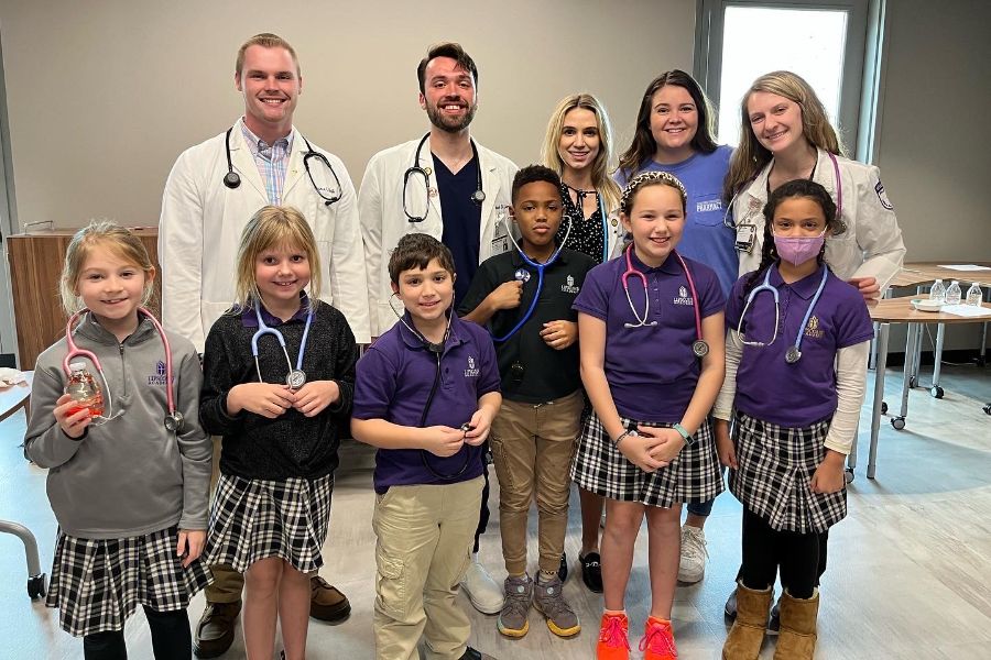 Lipscomb Pharmacy students pose with Lipscomb Academy students. 