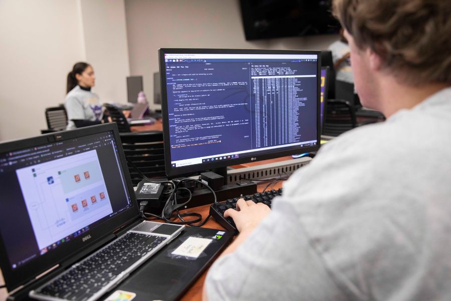 Student practices cyber defense at computer screen