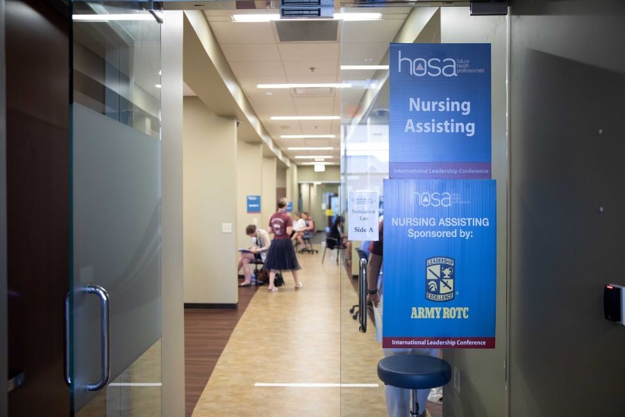 Glass door with HOSA welcome sign 