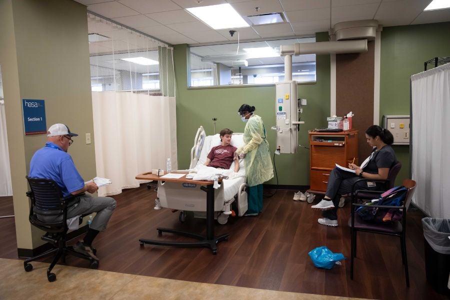 Two students participate in a hospital simulation