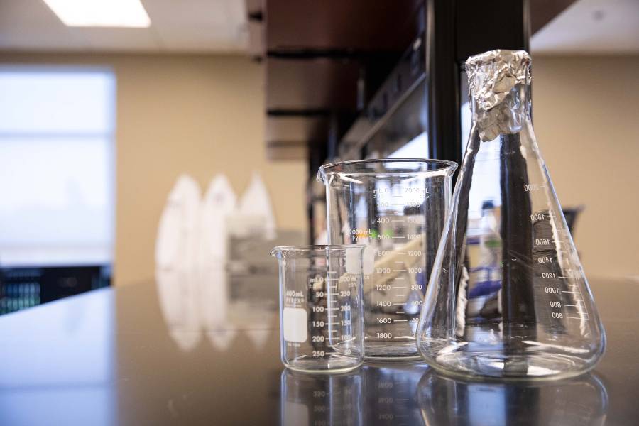 Beakers sitting on a lab table. 