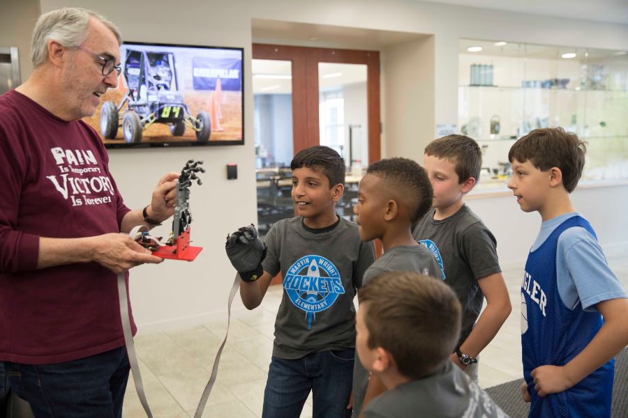 Greg Nordstrom demonstrating a robotic hand at summer robotics camp