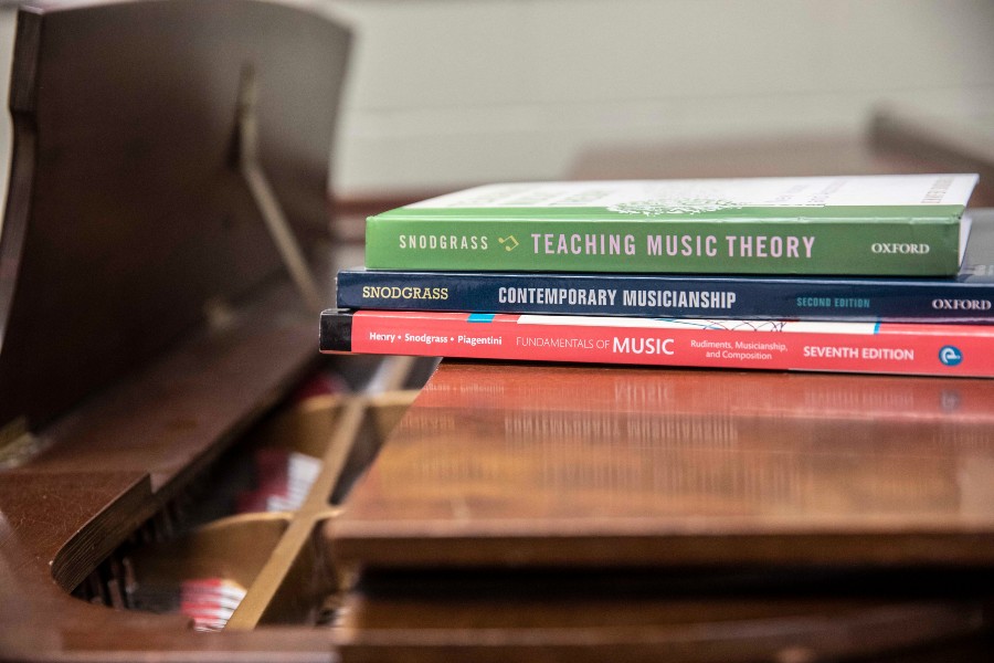 Snodgrass' books sitting on a piano