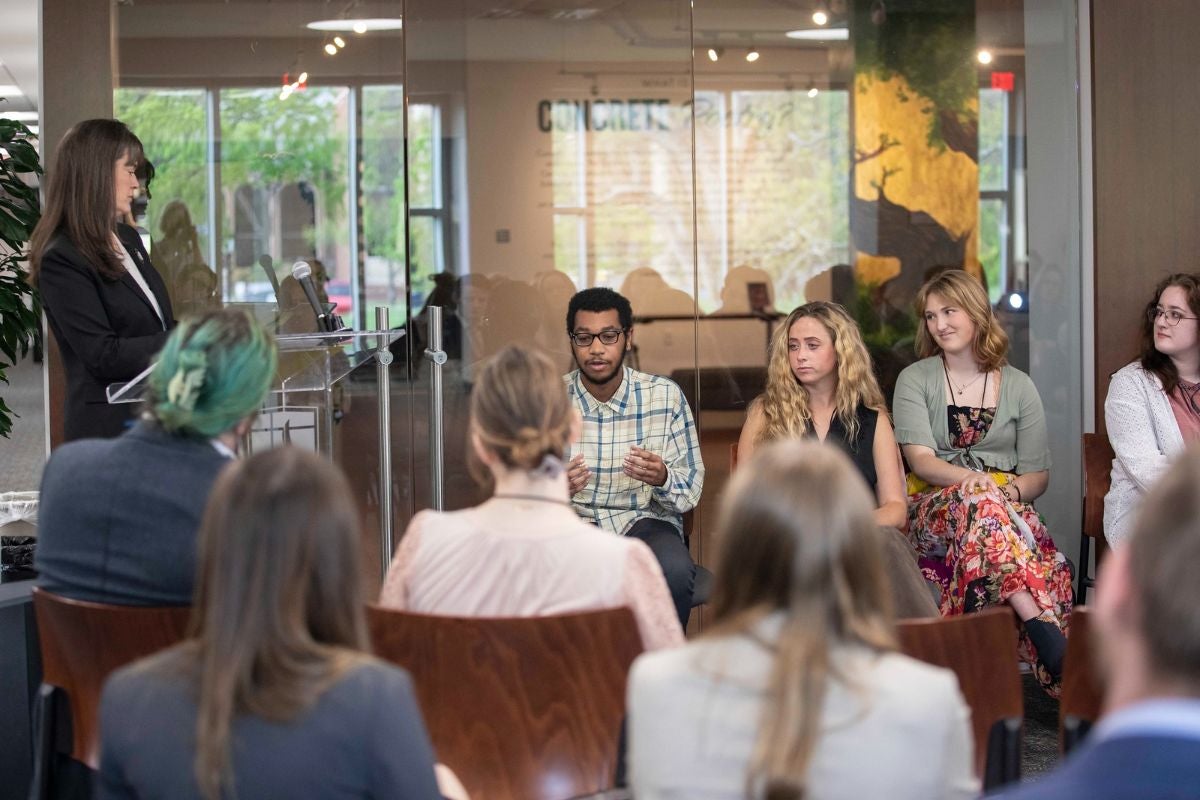 Students sitting and talking at the Student Scholars Symposium