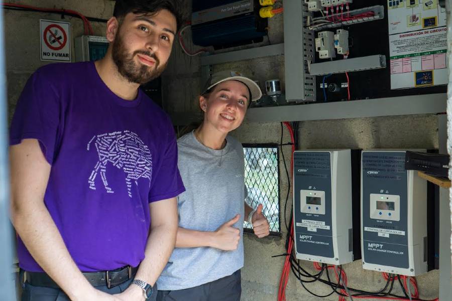 Juan Hernandez and McKenna Shepherd working with some of the electronics for the solar system installation at La Llorona.
