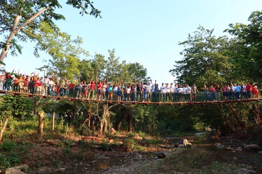 Engineering students and the community on the bridge the team completed in May.