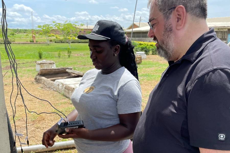 Associate Professor Dwayne Towell works with student Blessing Dayit, who is from Africa, to diagnose the wastewater treatment system Lipscomb installed there.