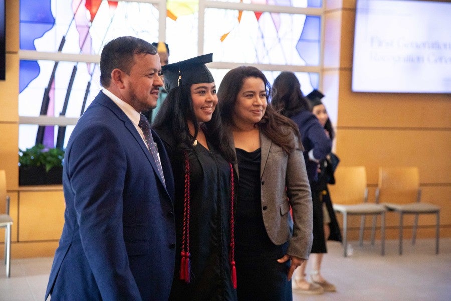 A May 2023 graduate and her family posing for photos