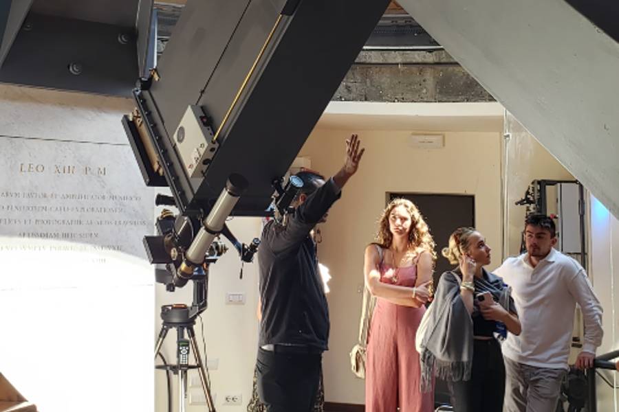 Faith and science students learning about a telescope in the Castel Gandolfo, the location of the Vatican Observatory.