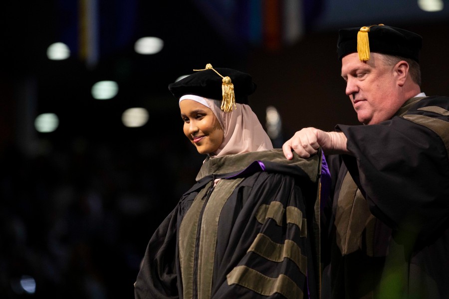 Muna Said being hooded at the May 2023 commencement