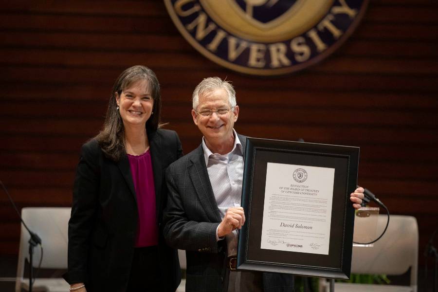 Lipscomb President Candice McQueen presents David Solomon with a proclamation from the Board of Trustees in honor of his service to the institution.