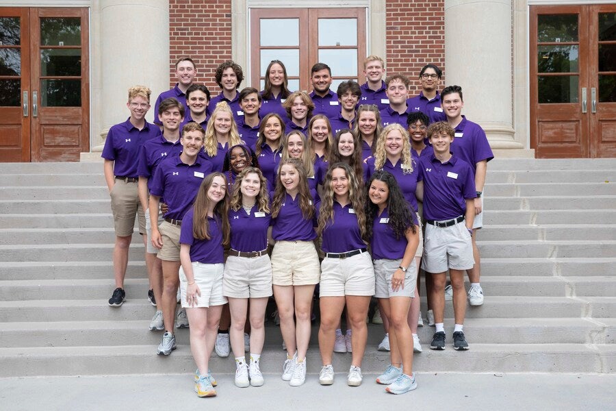 The Quest Team stands in front of Collins Alumni Auditorium