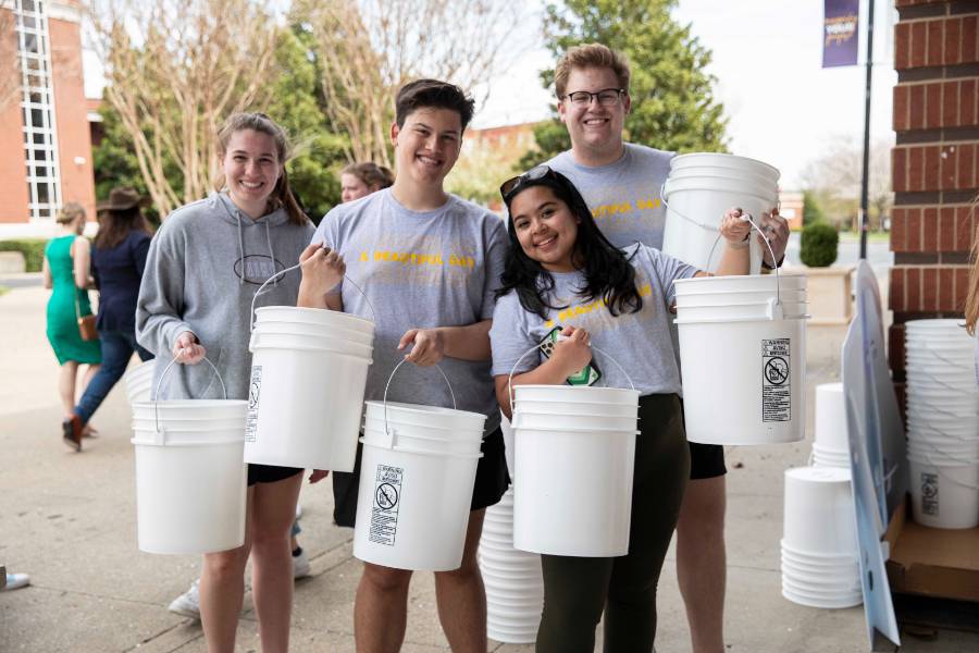 students with packed buckets