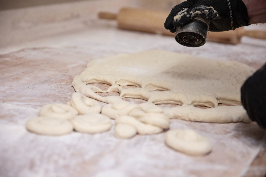 Cutting dough to make donuts