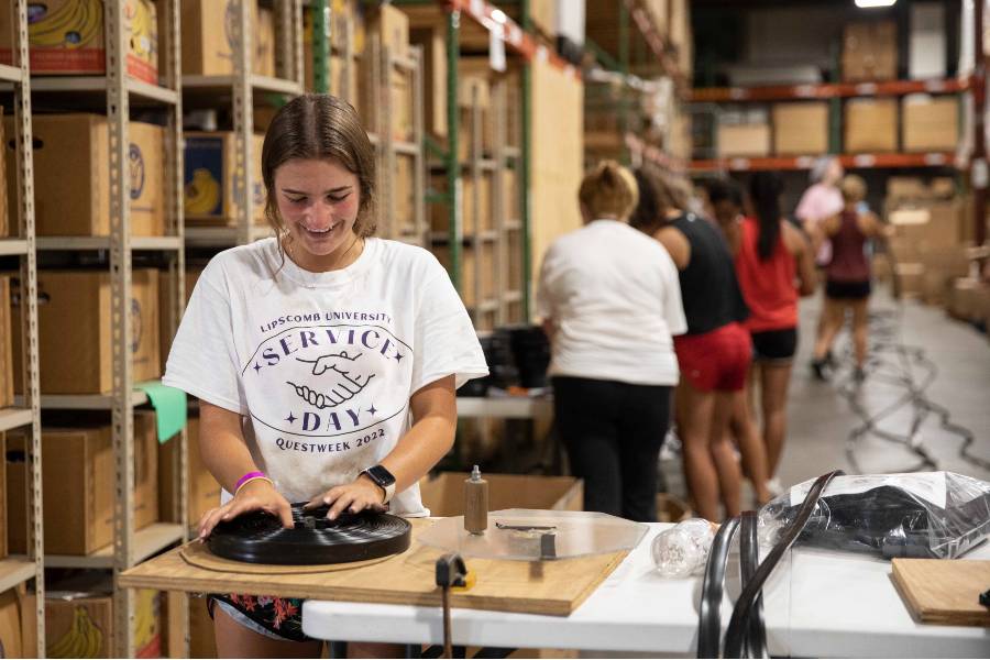 Student packing items in the HHI warehouse