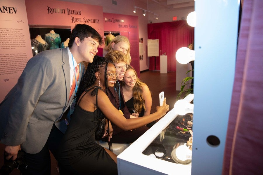 Lipscomb students at the make-up table at the exhibit