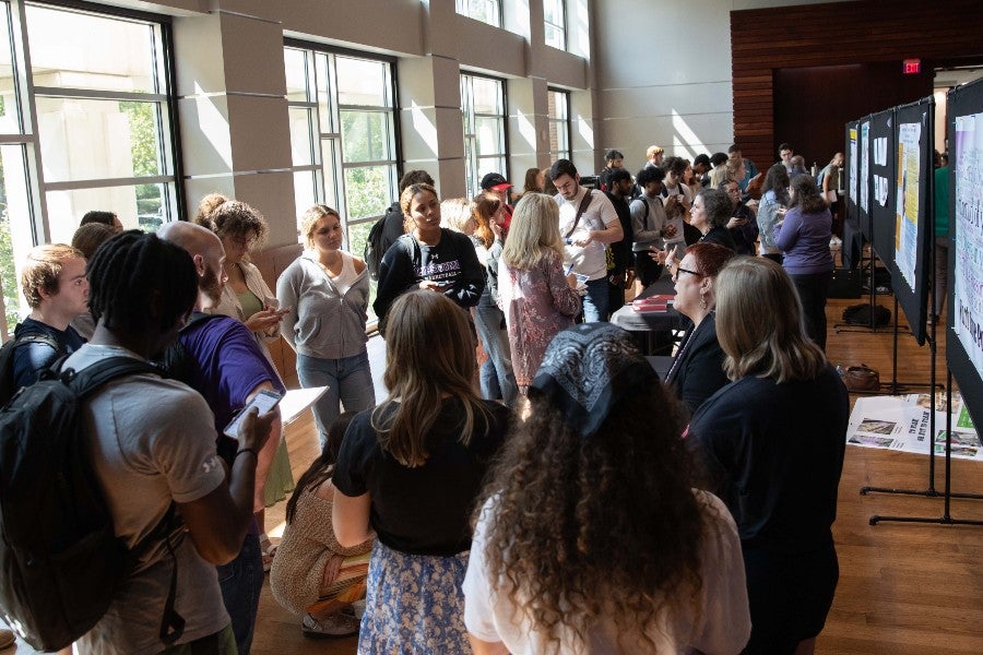 Students gathered around presenters at the event