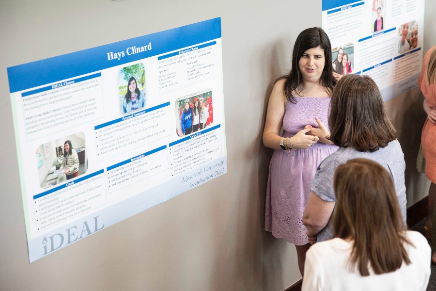 IDEAL grad making poster presentation at the ceremony