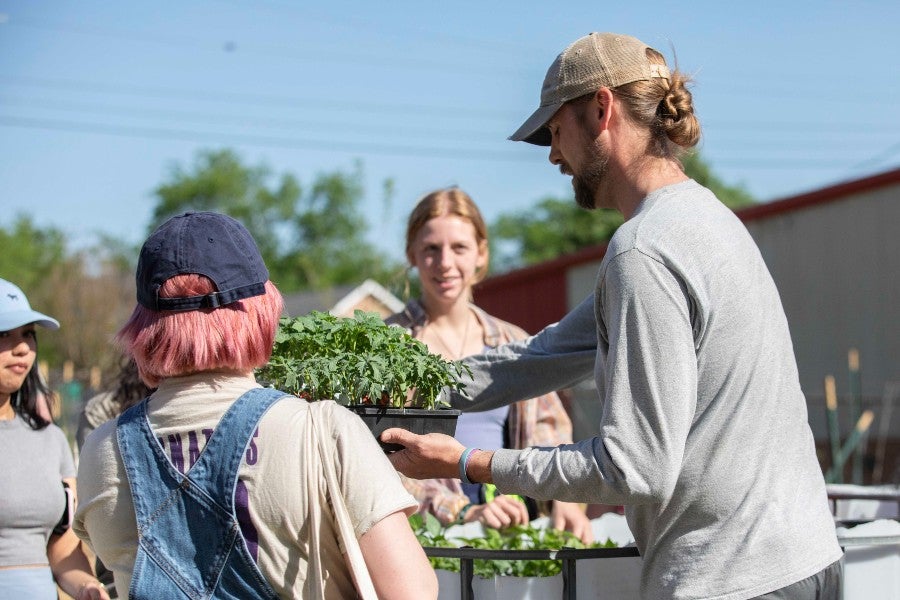 Nathan Hale working with students at the Madison church garden