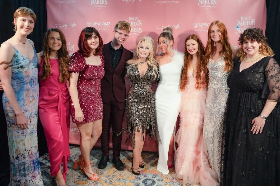 Lipscomb Students team leaders posing with Dolly Parton at the opening 