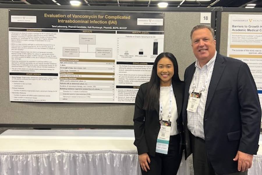 Campbell with student at scholars symposium.