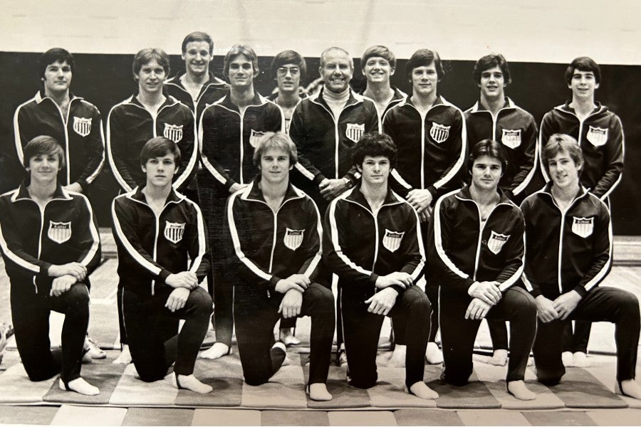 Members of the gymnastics team in years past with Coach Hanvey (center)