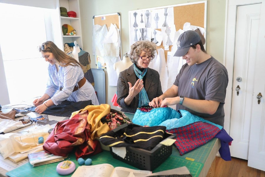 June Kingsbury work with students pinning costumes