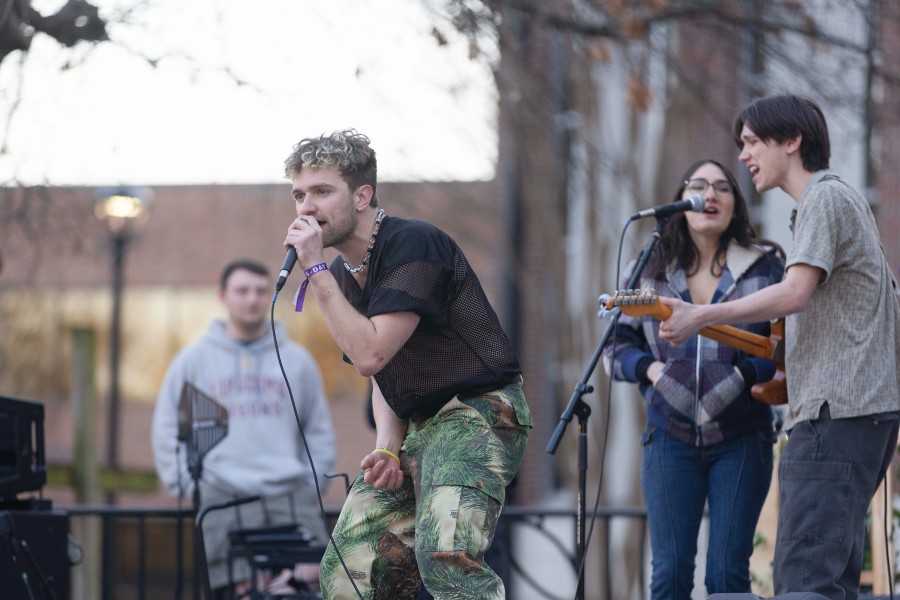 Students performing in daytime concert stage on Collins steps.