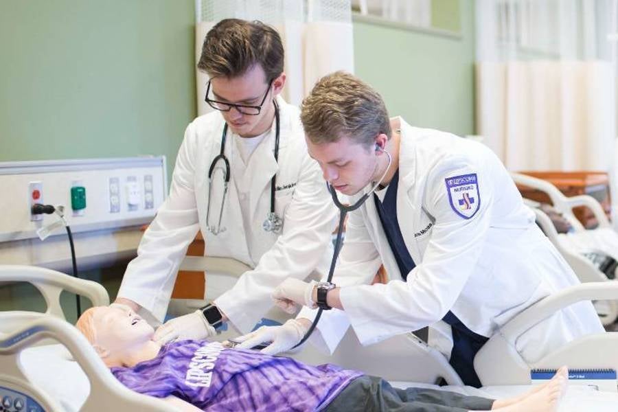 Two students in simulation lab.