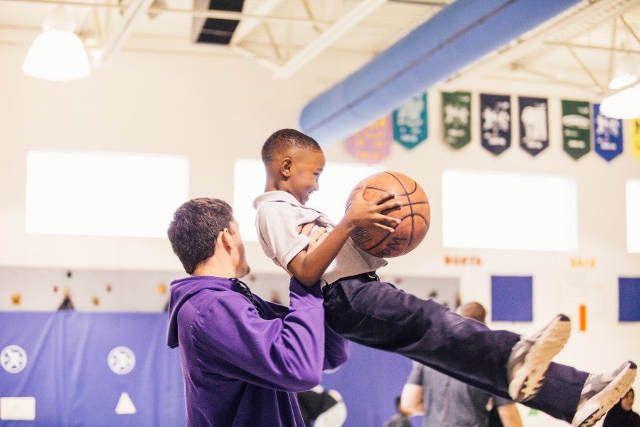 Student athletes playing with students at Carter-Lawrence Elementary School