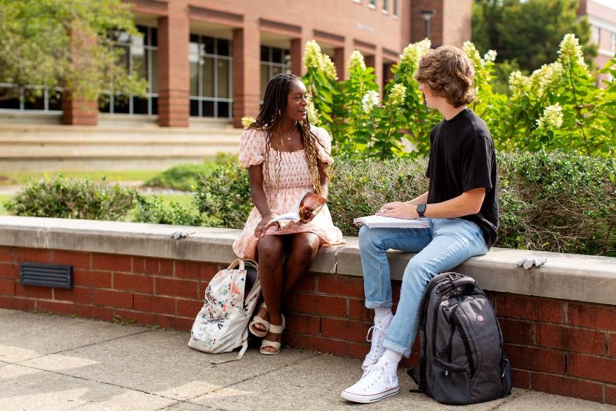 Students sitting in Bison Square studying.